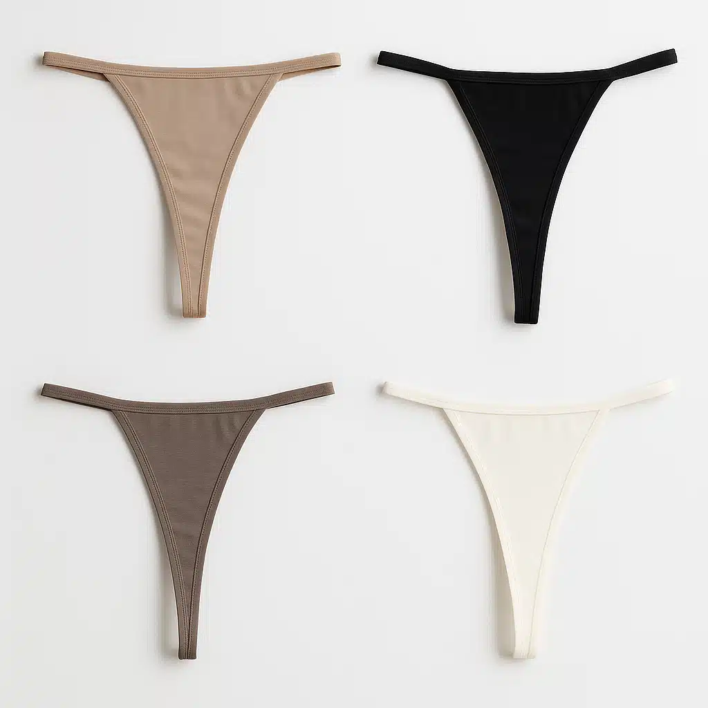 Various thong style underwear showing different back strap widths and front coverage options, arranged to display the minimal line design, neutral colors, professional product photography against white background