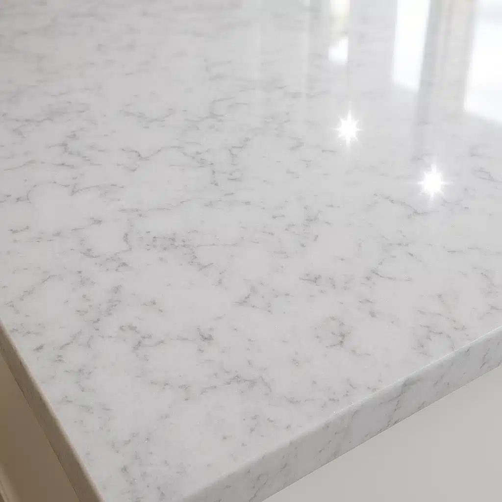 Sparkling clean quartz countertop surface after successful rust removal, showing restored shine and unblemished appearance, bright natural lighting highlighting the polished finish and natural stone pattern